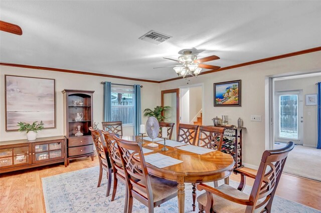 dining space with a ceiling fan, visible vents, light wood-style floors, and stairway