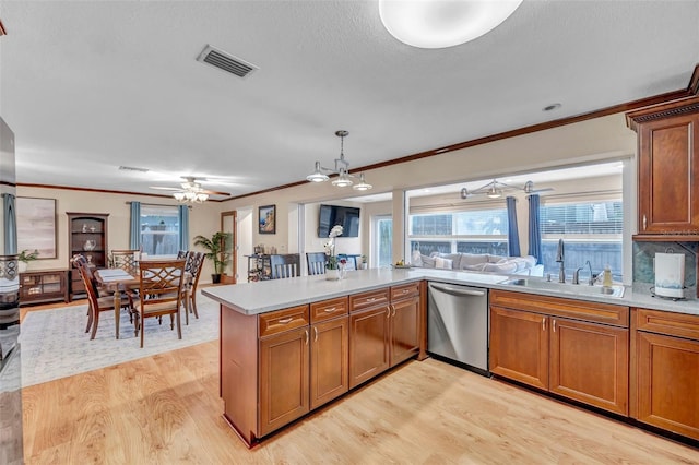 kitchen with a sink, dishwasher, ceiling fan, light wood finished floors, and visible vents