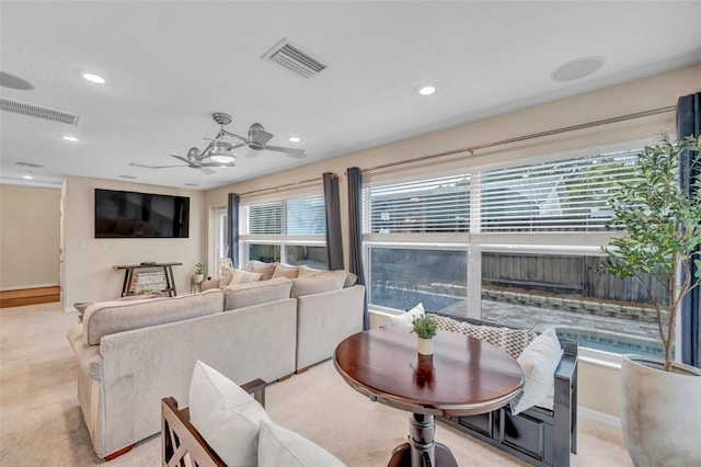 carpeted living area with ceiling fan, baseboards, visible vents, and recessed lighting
