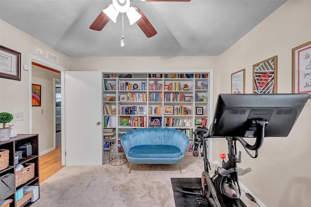 workout area with a ceiling fan, carpet flooring, and visible vents