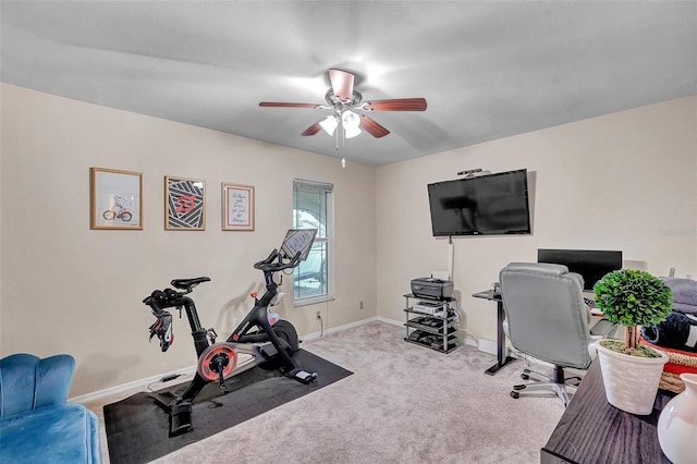 exercise area featuring baseboards, a ceiling fan, and carpet flooring