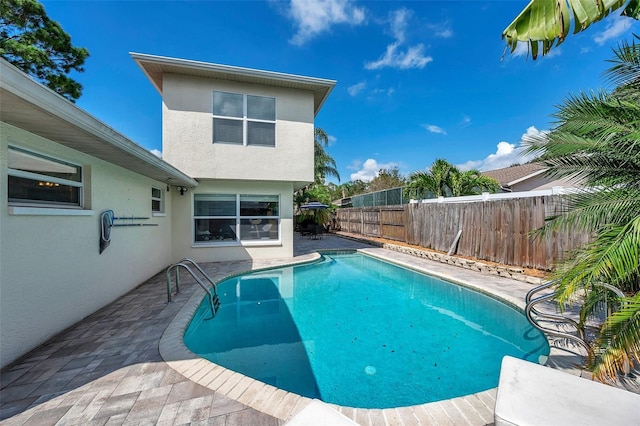 view of swimming pool with a patio area, a fenced backyard, and a fenced in pool