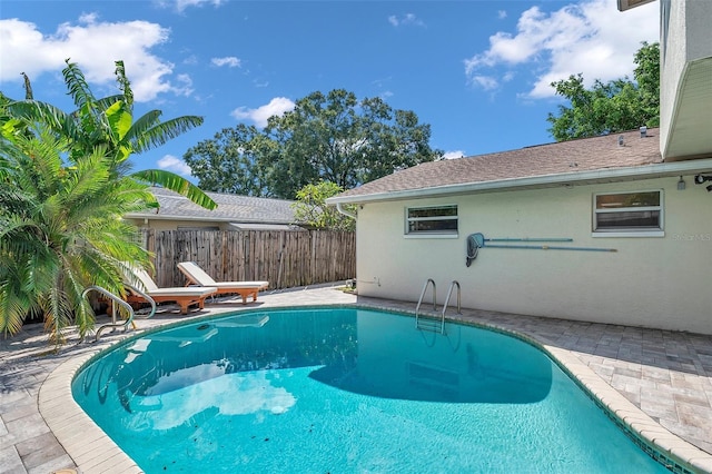 view of pool featuring fence, a fenced in pool, and a patio