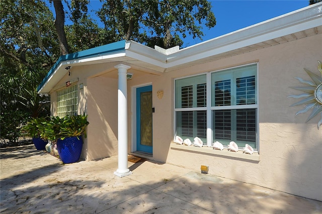 doorway to property with a patio area