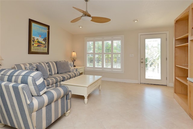 living room featuring ceiling fan and light tile patterned floors