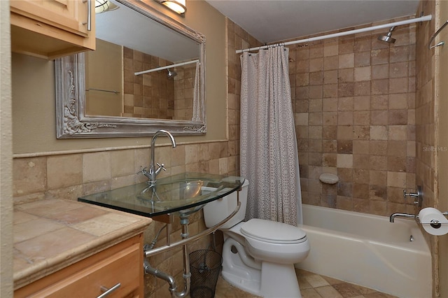 full bathroom featuring toilet, shower / bath combo with shower curtain, tile walls, vanity, and decorative backsplash