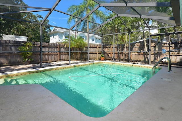 view of swimming pool with a patio and a lanai