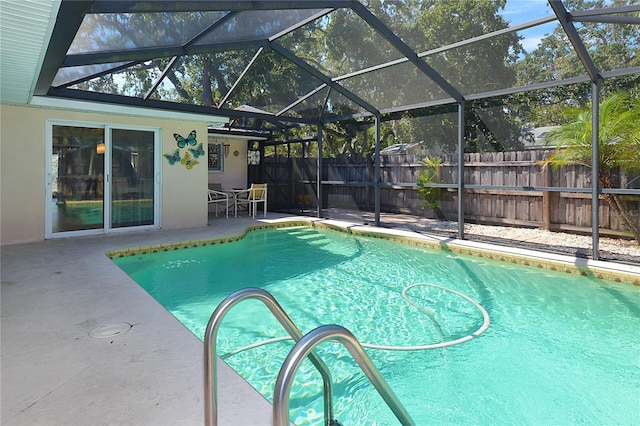 view of swimming pool featuring a patio area and a lanai