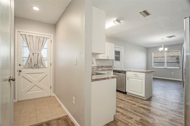 kitchen featuring white cabinets, dishwasher, light hardwood / wood-style flooring, and kitchen peninsula