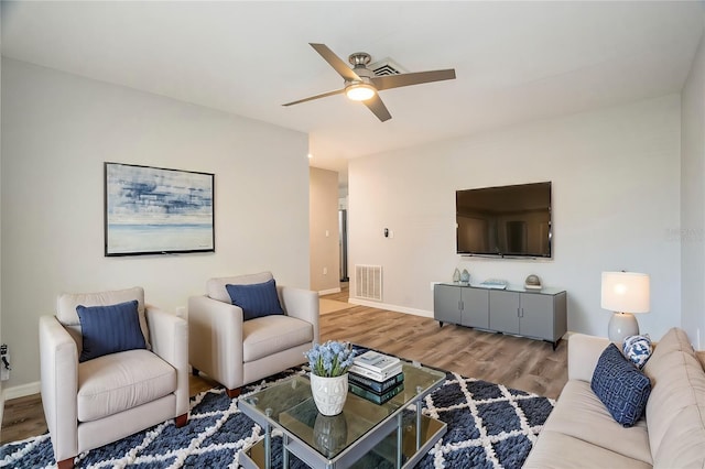 living room featuring hardwood / wood-style flooring and ceiling fan