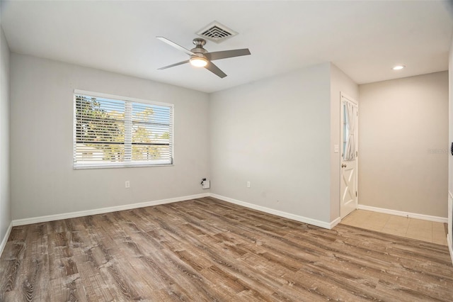 unfurnished room with hardwood / wood-style flooring and ceiling fan