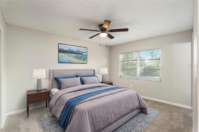 bedroom featuring light colored carpet and ceiling fan