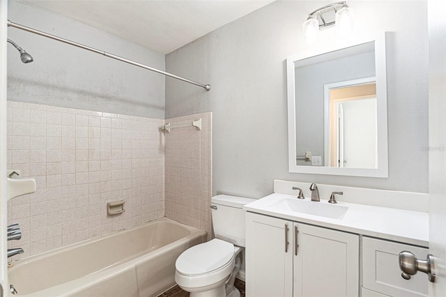 full bathroom with toilet, tiled shower / bath combo, and vanity