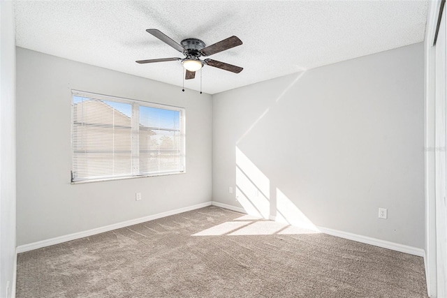 carpeted spare room with ceiling fan and a textured ceiling