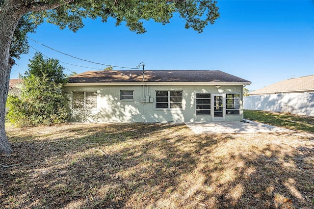 back of house with a lawn