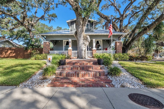 view of front facade with covered porch and a front yard