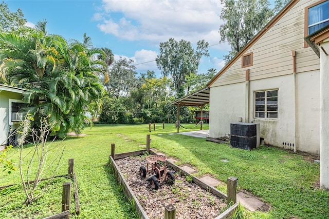 view of yard featuring cooling unit and a patio area