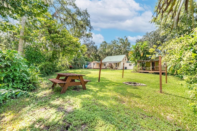 view of yard featuring a fire pit and a deck