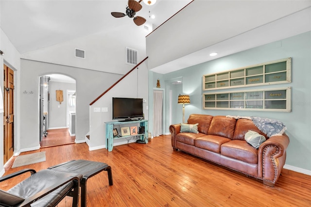 living room featuring high vaulted ceiling, ceiling fan, and hardwood / wood-style flooring