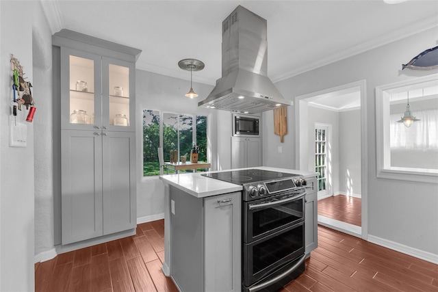 kitchen with ornamental molding, island exhaust hood, dark hardwood / wood-style floors, electric range, and a center island