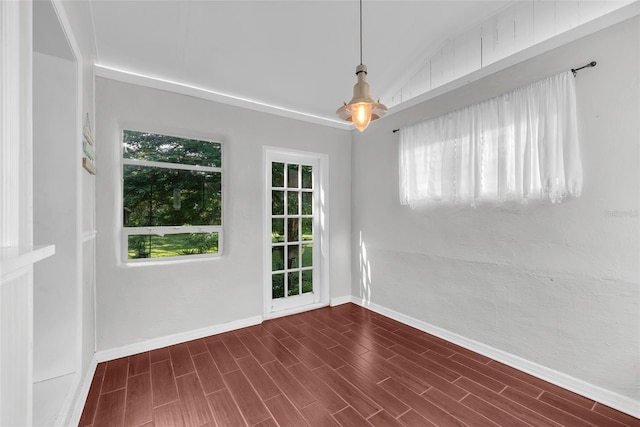 spare room featuring vaulted ceiling and dark hardwood / wood-style floors