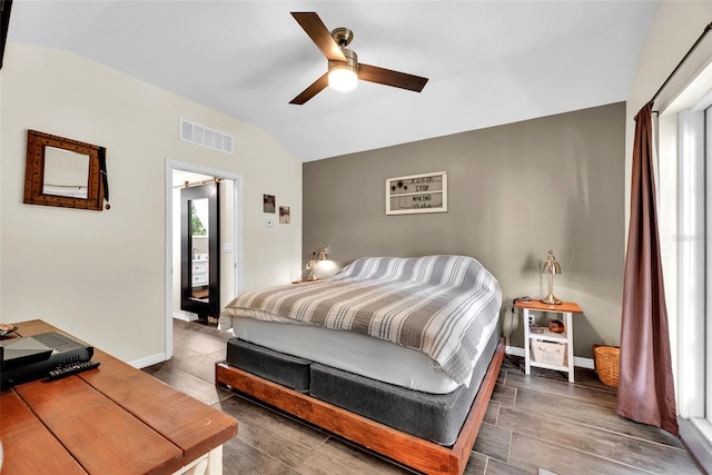 bedroom featuring vaulted ceiling, ceiling fan, and dark wood-type flooring