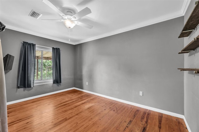 spare room featuring ceiling fan, hardwood / wood-style flooring, and ornamental molding