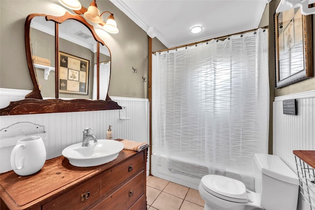 full bathroom featuring vanity, ornamental molding, shower / bath combo with shower curtain, tile patterned floors, and toilet