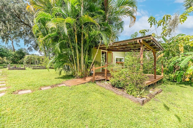 view of yard with a wooden deck and a pergola