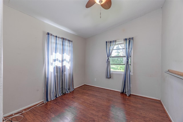 spare room featuring lofted ceiling, dark hardwood / wood-style flooring, and ceiling fan