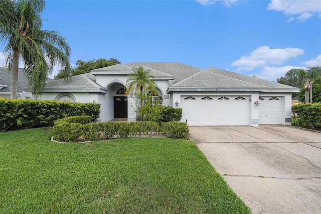 view of front facade with a garage and a front yard