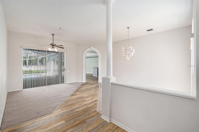 hall with hardwood / wood-style floors and an inviting chandelier