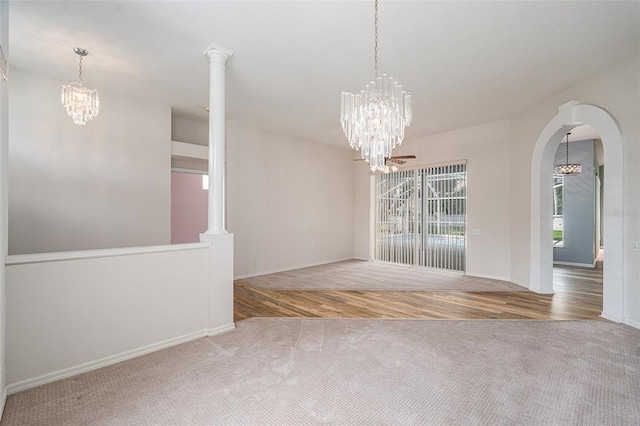 unfurnished dining area featuring light hardwood / wood-style floors and decorative columns