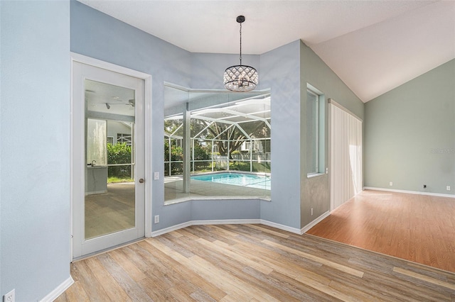 doorway to outside featuring hardwood / wood-style flooring and lofted ceiling