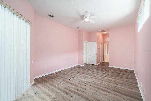 spare room featuring light hardwood / wood-style flooring, a textured ceiling, and ceiling fan