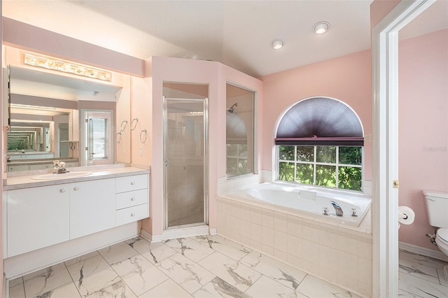 full bathroom featuring vanity, shower with separate bathtub, and toilet