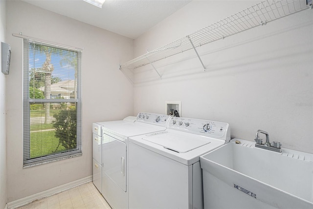 laundry area with washer and dryer and sink