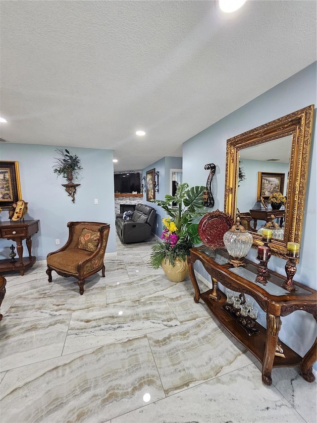 4810 N Galloway Rd, Lakeland, FL 33810 - living room featuring a fireplace, a textured ceiling, and recessed lighting