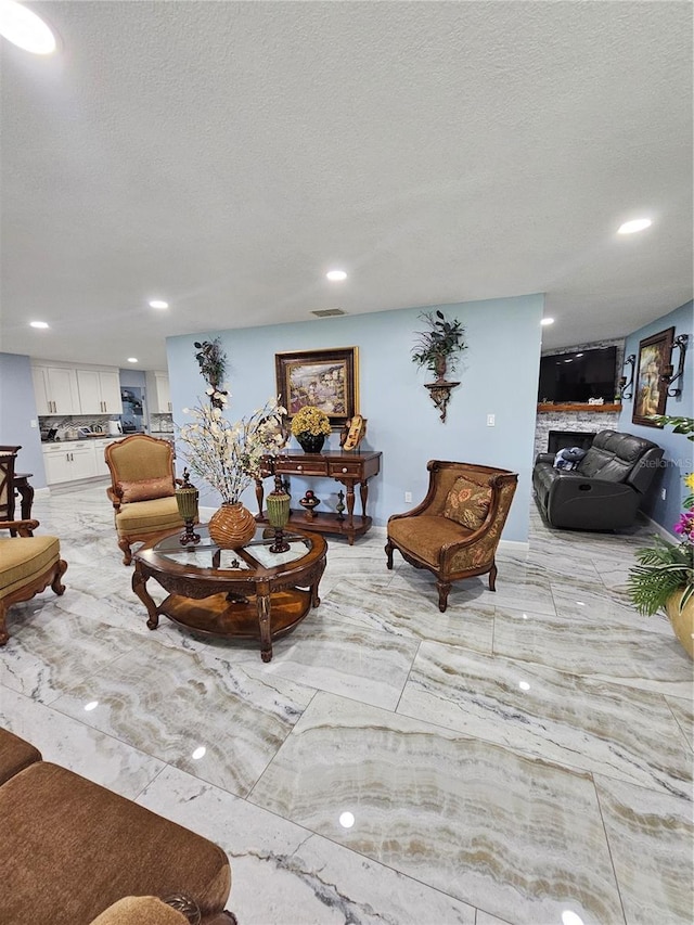 4810 N Galloway Rd, Lakeland, FL 33810 - living area with a textured ceiling, recessed lighting, and a fireplace
