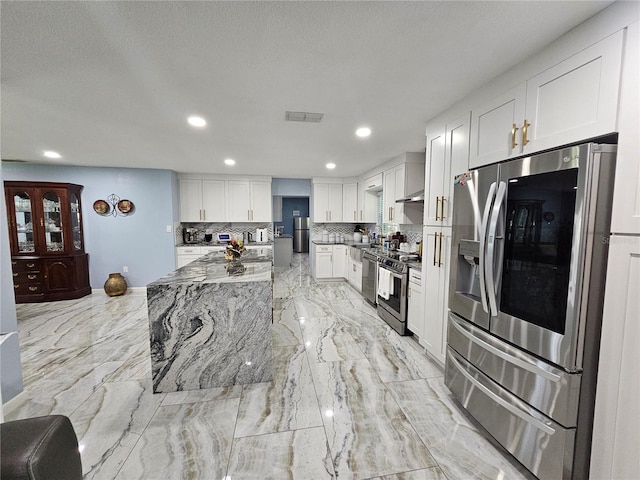 4810 N Galloway Rd, Lakeland, FL 33810 - kitchen with stainless steel appliances, backsplash, white cabinets, recessed lighting, and light stone counters