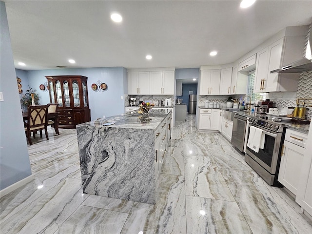 4810 N Galloway Rd, Lakeland, FL 33810 - kitchen with appliances with stainless steel finishes, decorative backsplash, white cabinets, dark stone countertops, and recessed lighting