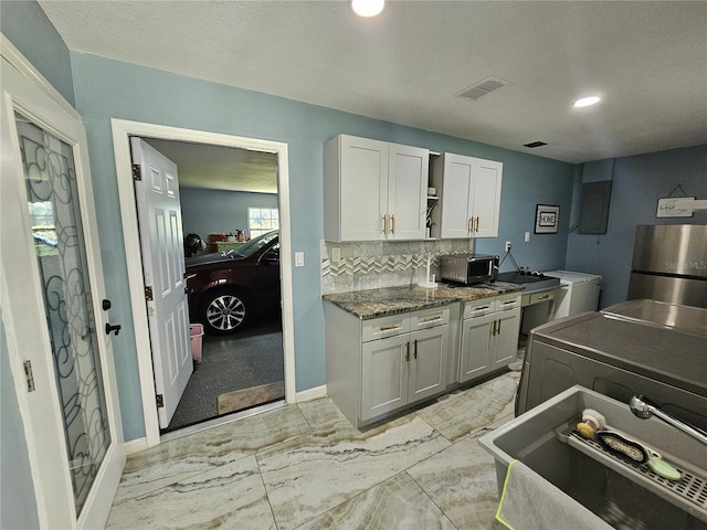 4810 N Galloway Rd, Lakeland, FL 33810 - kitchen with independent washer and dryer, baseboards, tasteful backsplash, recessed lighting, and appliances with stainless steel finishes