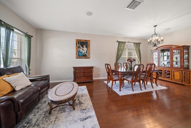 living room with a notable chandelier and dark hardwood / wood-style floors