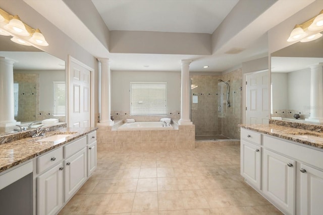 bathroom featuring shower with separate bathtub, vanity, and ornate columns