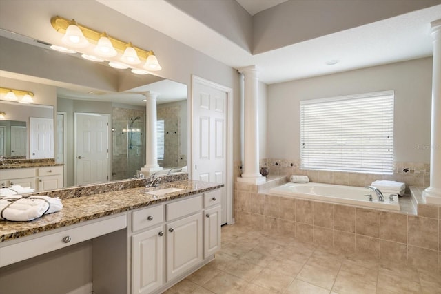 bathroom featuring tile patterned flooring, independent shower and bath, vanity, and ornate columns