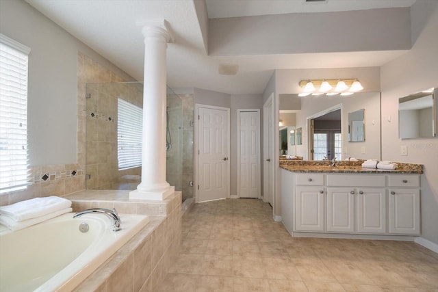 bathroom featuring decorative columns, vanity, separate shower and tub, and a wealth of natural light