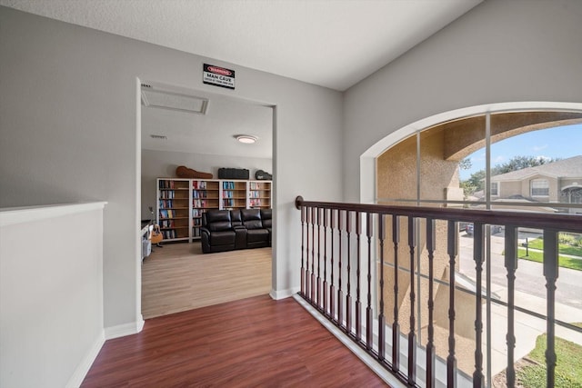 hall featuring a textured ceiling and hardwood / wood-style flooring