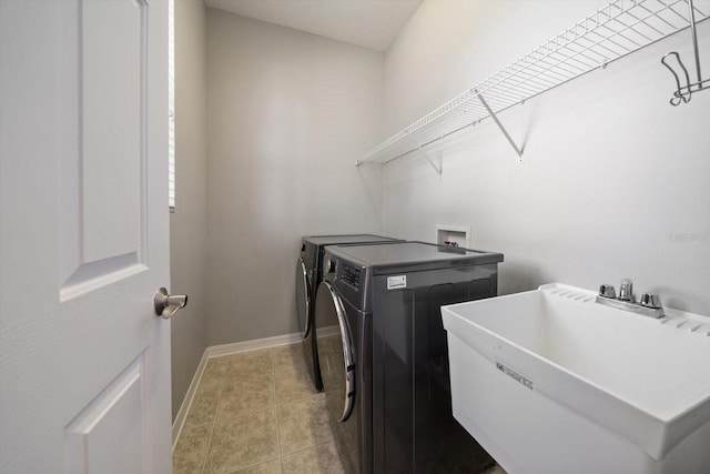 laundry area with light tile patterned floors, sink, and independent washer and dryer