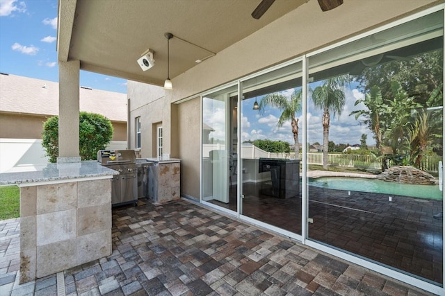 view of patio / terrace featuring ceiling fan and exterior kitchen