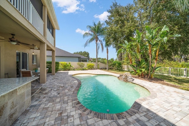 view of pool with ceiling fan and a patio